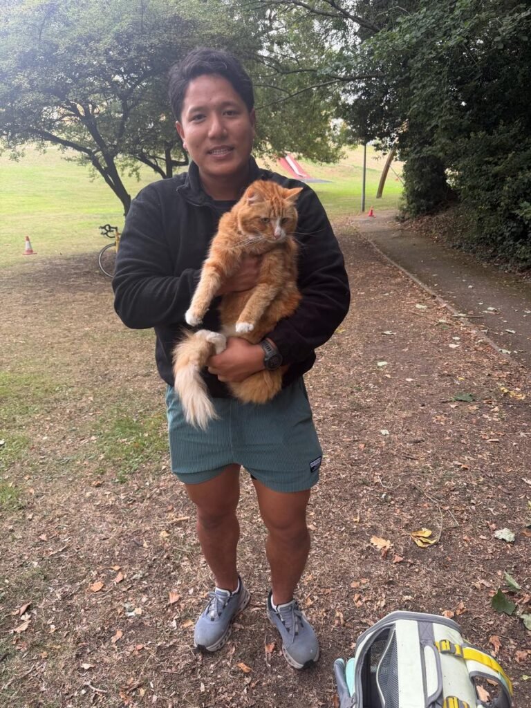 Owner holding Momo, a ginger cat, after the tree rescue in Maidstone