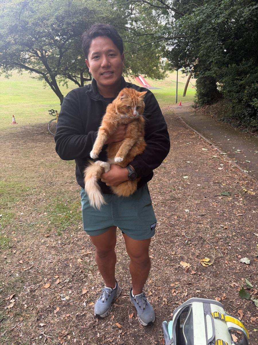 Owner holding Momo, a ginger cat, after the tree rescue in Maidstone